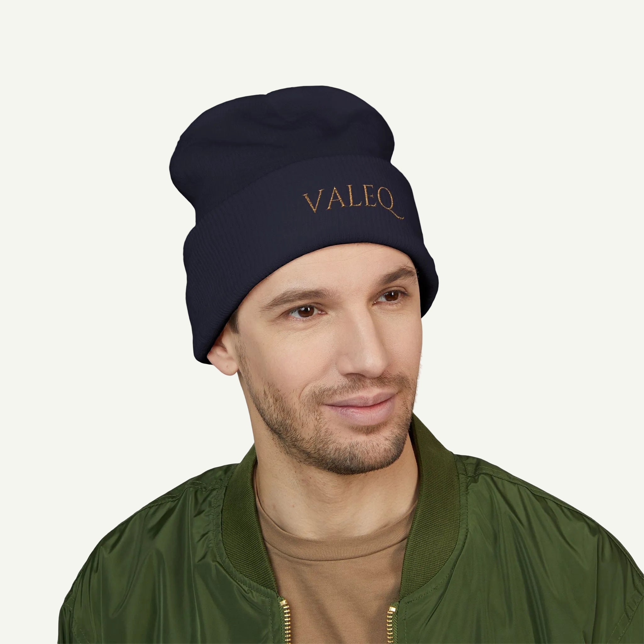 Man wearing a navy beanie with 'VALEO' branding on a white background