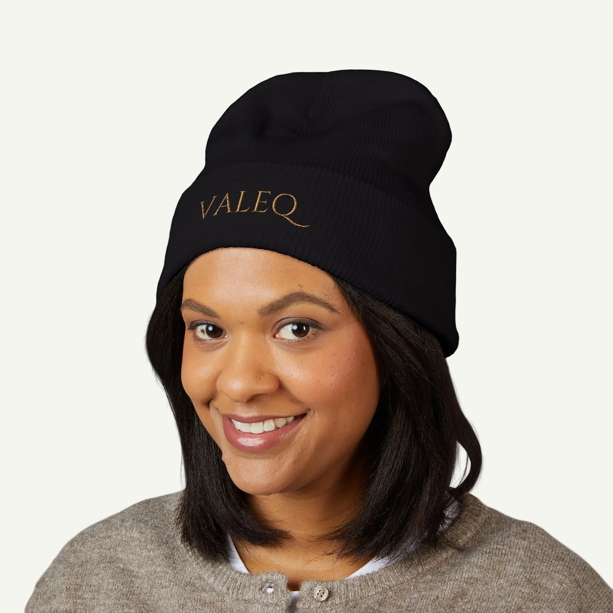 Person wearing a black beanie with 'VALEQ' logo on a white background