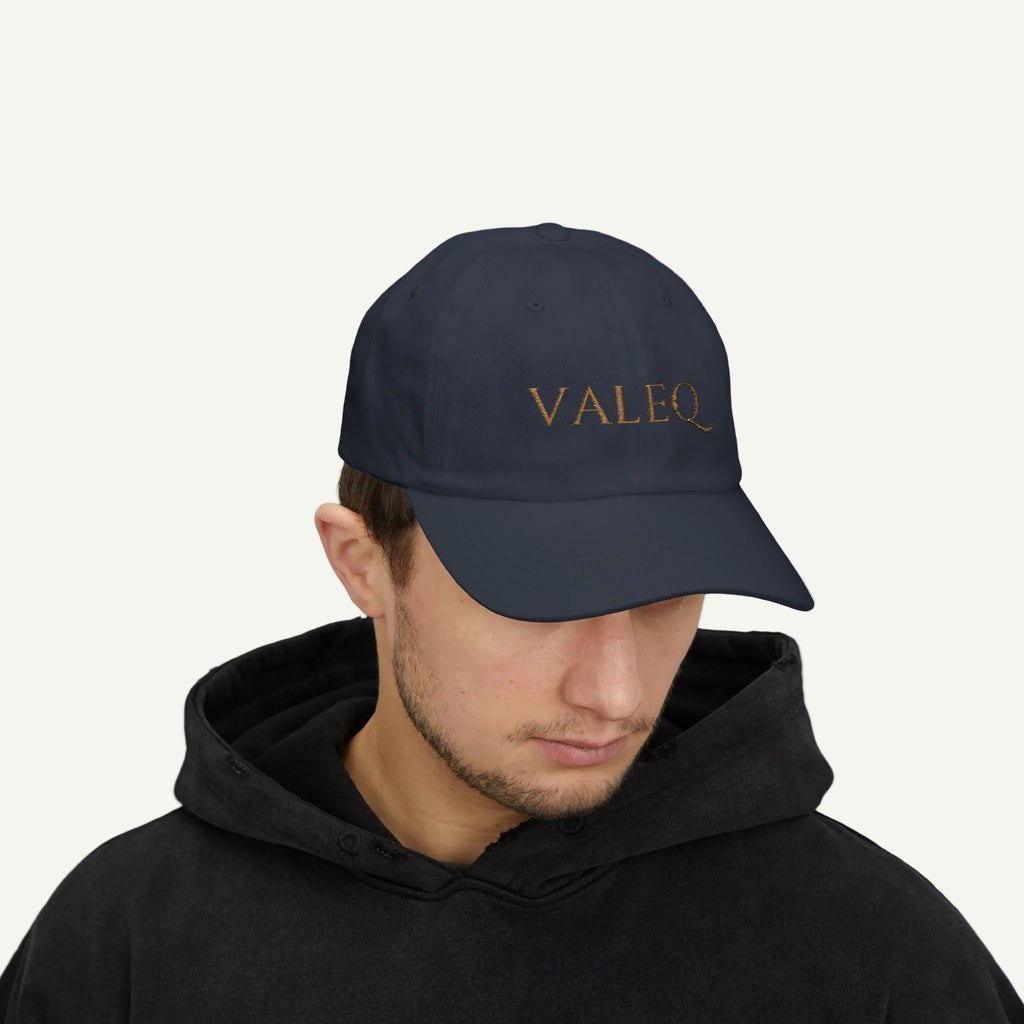 Person wearing a navy cap with 'VALEO' logo on a white background