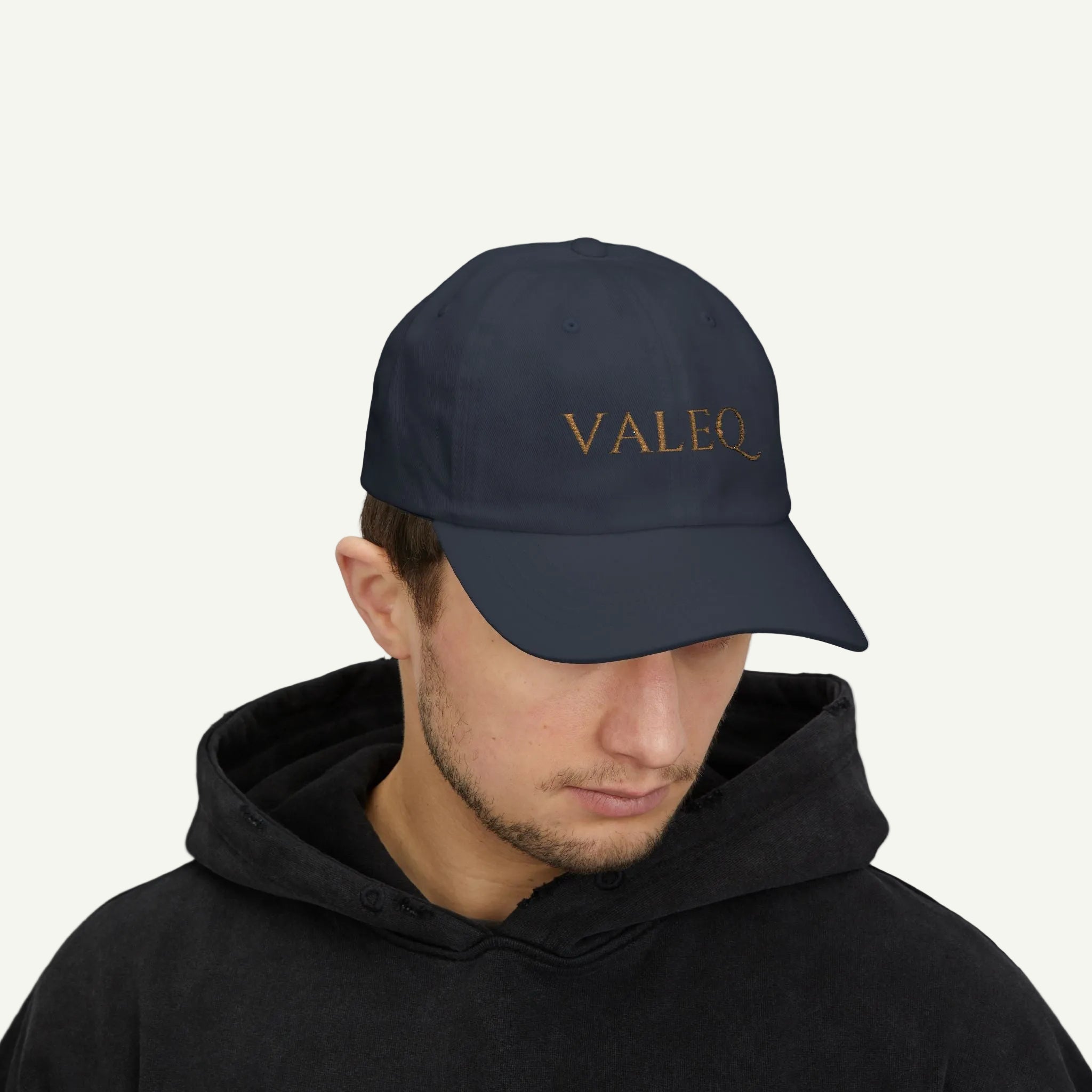 Person wearing a navy cap with 'VALEO' logo on a white background