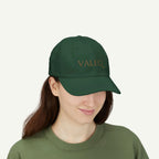 Person wearing a green cap with 'VALEQ' logo on a white background