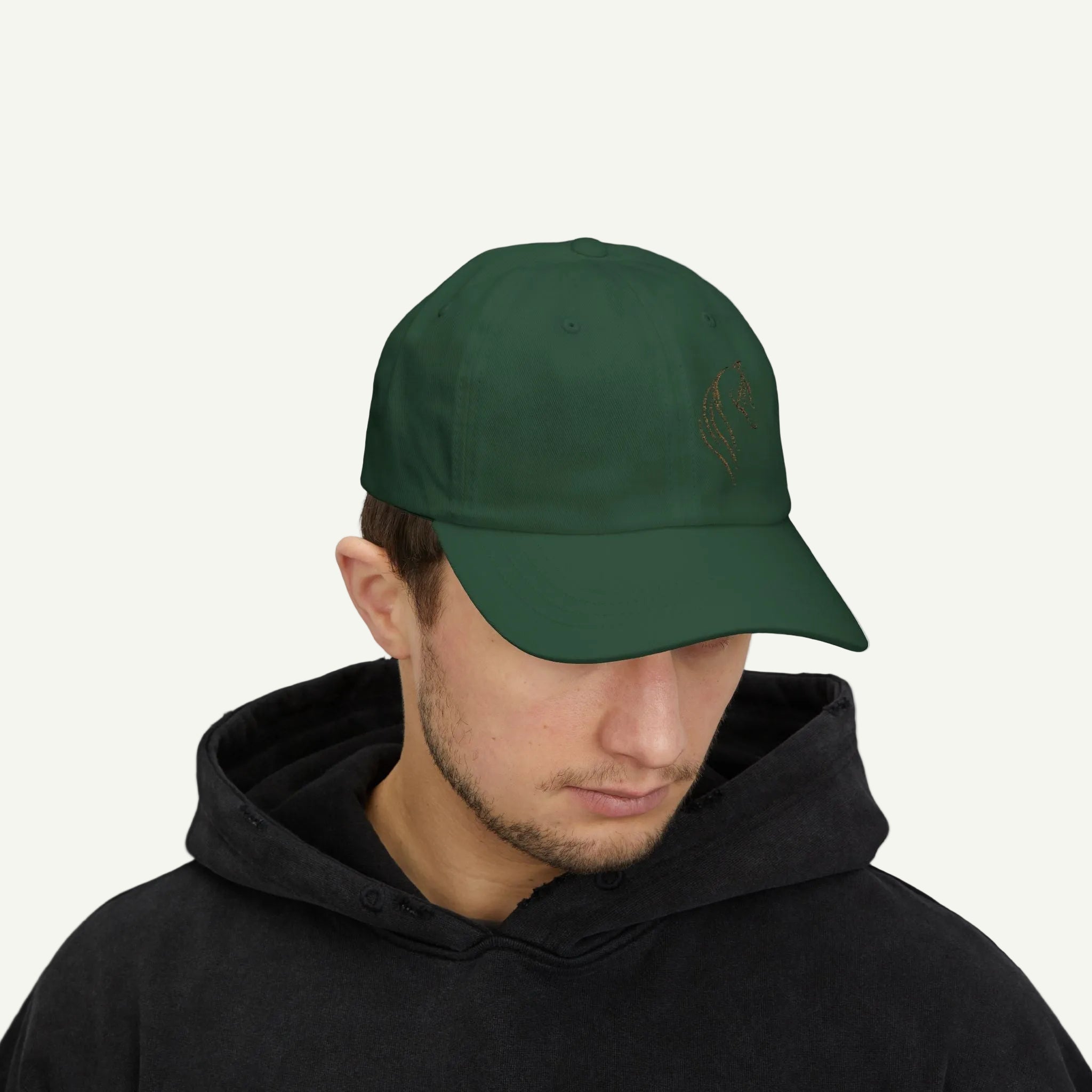 Person wearing a green cap and black hoodie on a white background