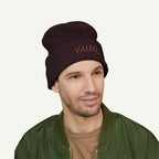 Man wearing a brown beanie with 'VALEQ' embroidery on a white background