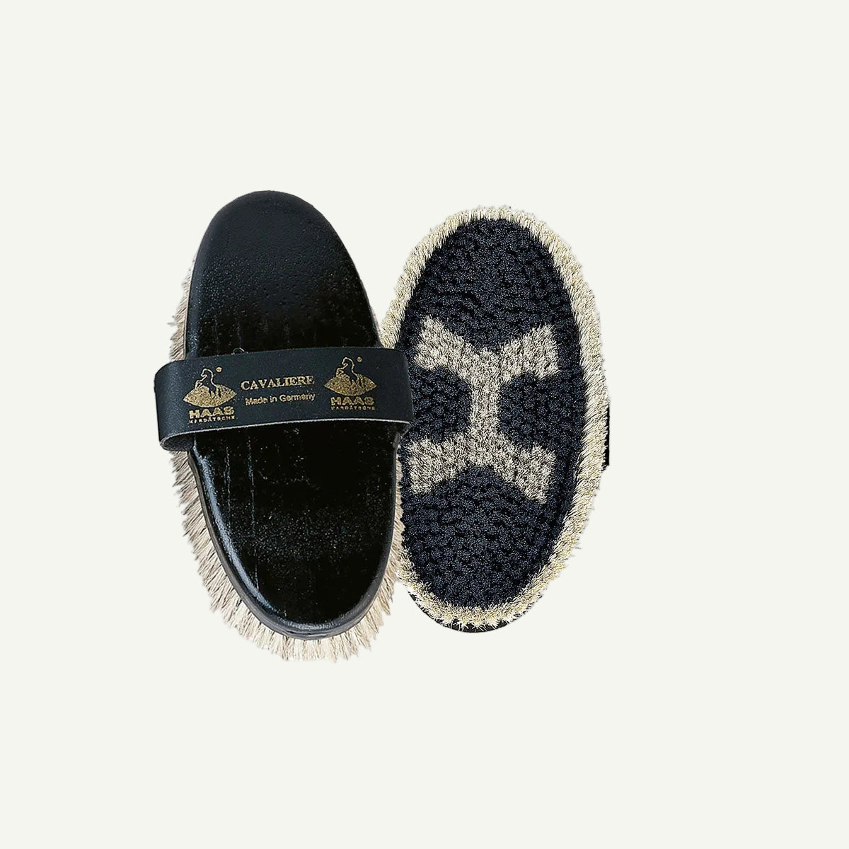 Pair of black and gray horse grooming brush with a visible brand label on a white background