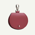 Red leather keychain pouch with a clasp on a white background