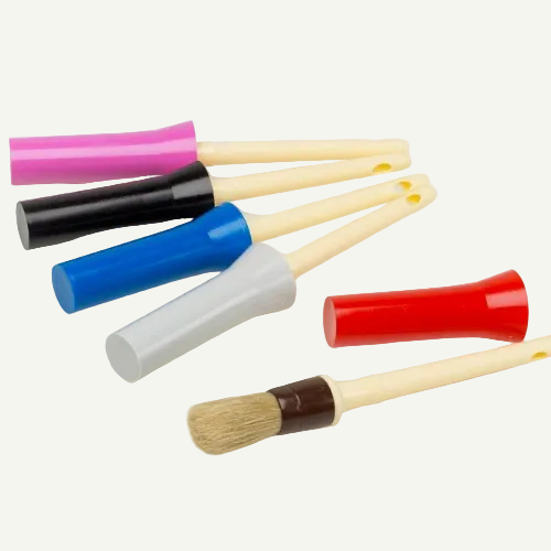Set of colorful brushes with wooden handles on a white background