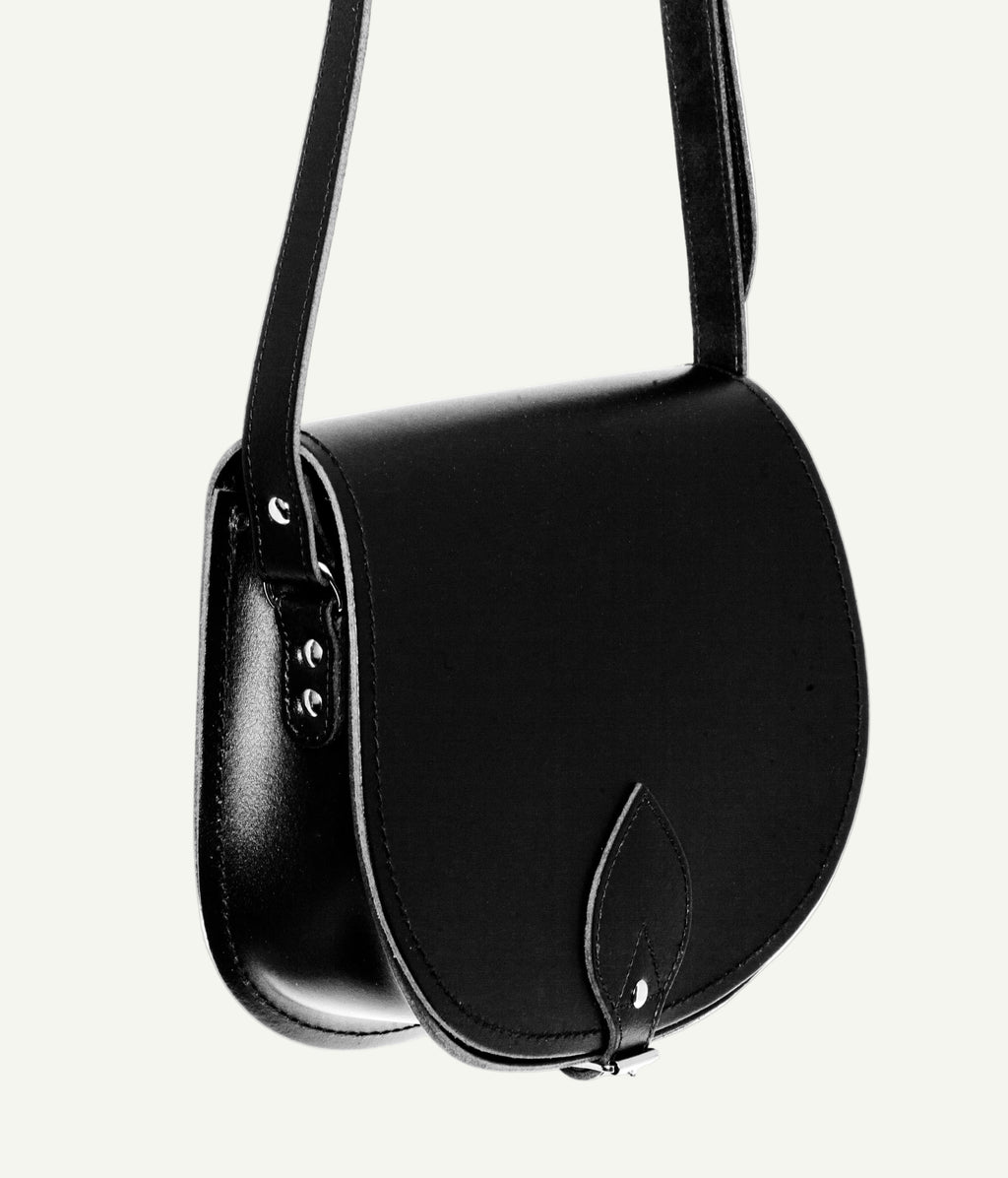 Black leather saddle bag on a white background