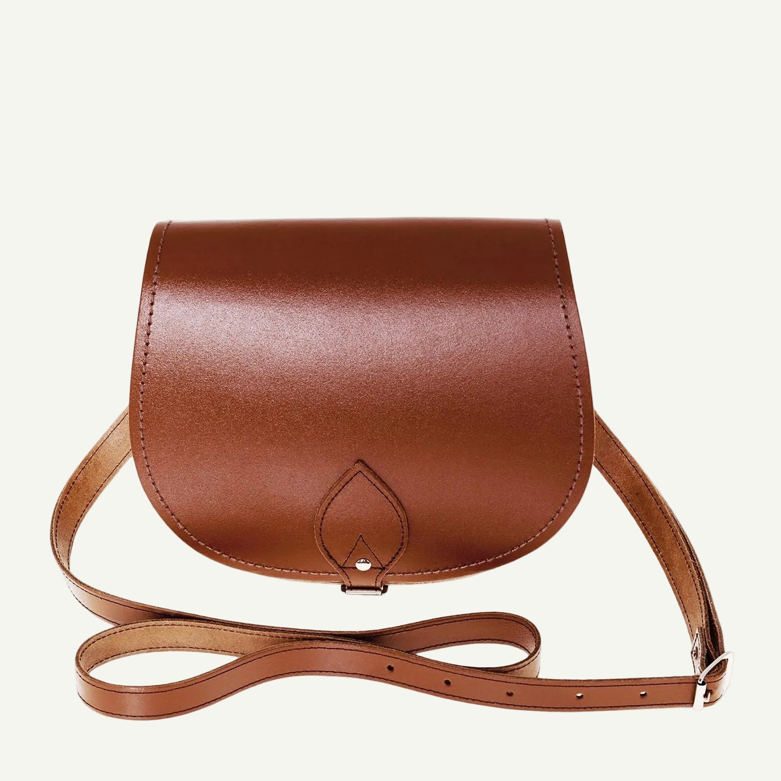 Brown leather handbag with a strap on a white background