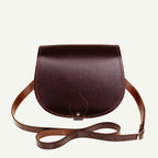 Brown leather saddle bag on a white background