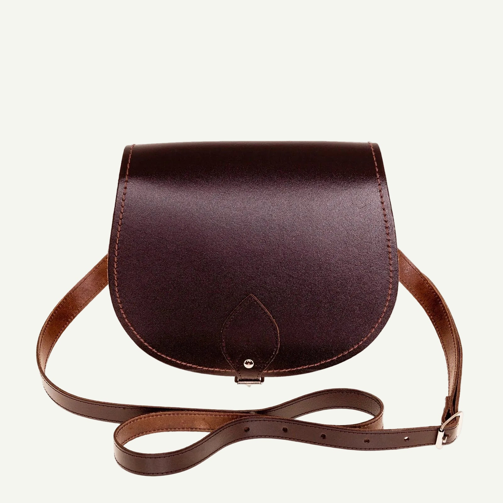 Brown leather saddle bag on a white background