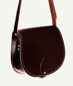 Brown leather saddle bag on a white background