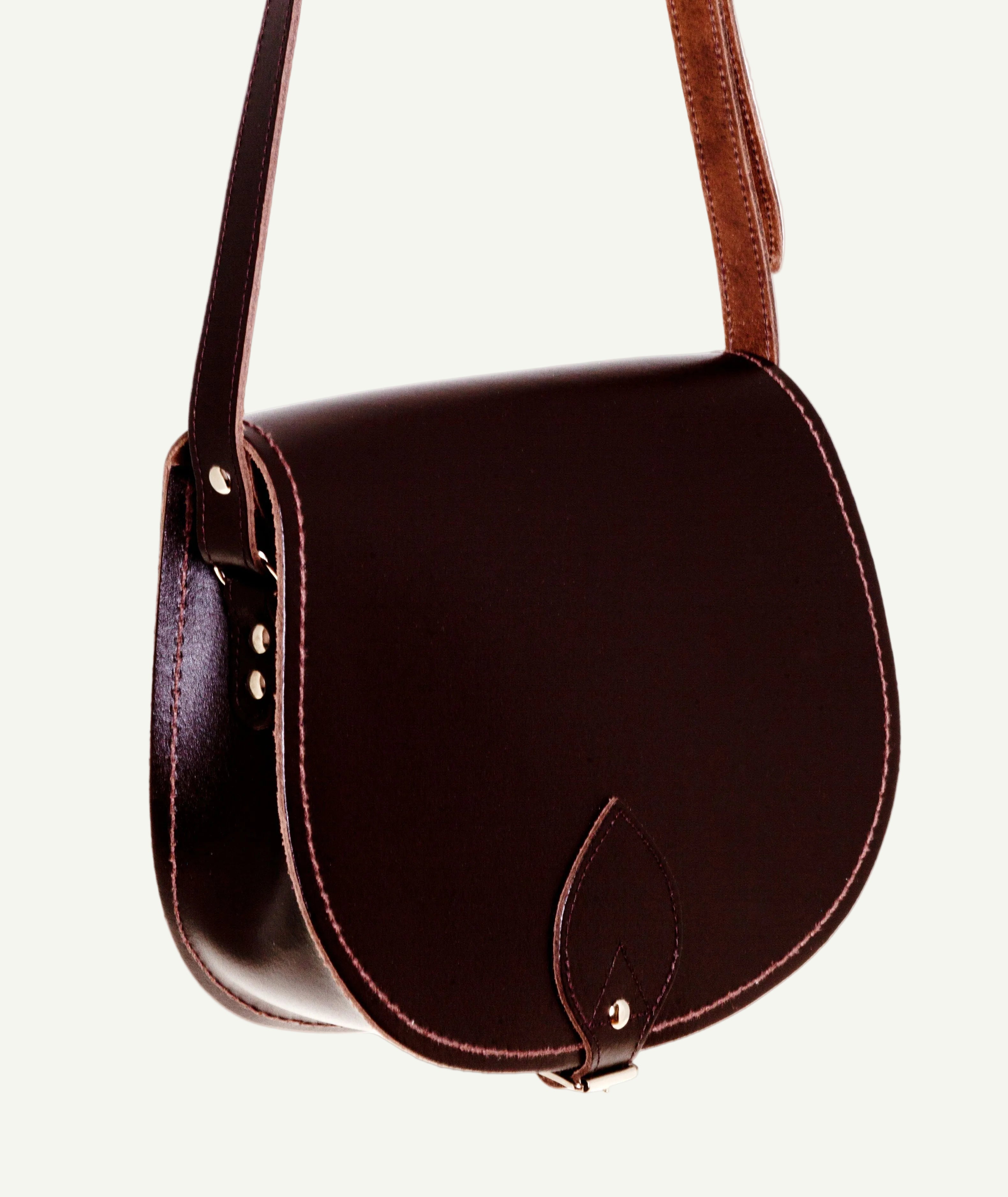 Brown leather saddle bag on a white background