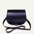 Navy leather saddle bag with a strap on a white background