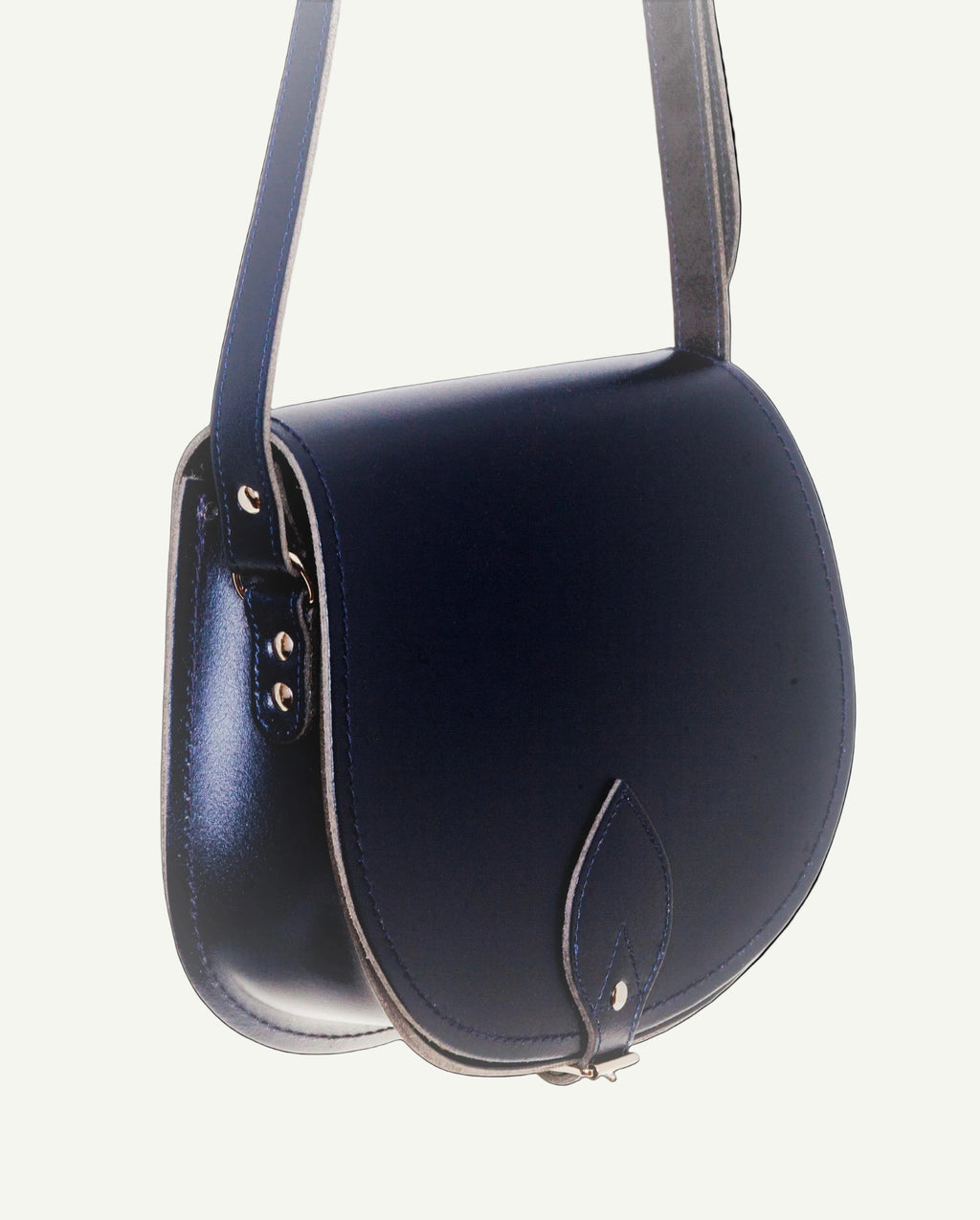 Navy blue leather handbag with a strap on a white background