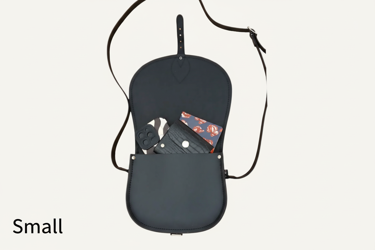 Small saddle bag with a black strap on a white background